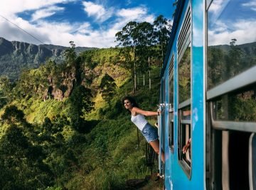 beautiful-girl-traveling-by-train-among-mountains-2023-11-27-05-11-55-utc
